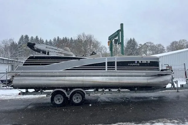 The Image of 2016 Harris Grand Mariner SEL 250 pontoon boat on trailer in snowy setting. - 0