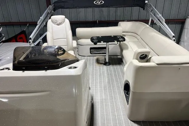 Slide: The Image of 2016 Harris Grand Mariner SEL 250 pontoon boat interior with plush seating and helm. - 13
