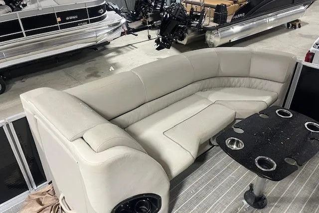 Slide: The Image of 2016 Harris Grand Mariner SEL 250 pontoon boat with beige seating and black table. - 8