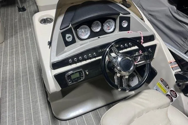 Slide: The Image of 2016 Harris Grand Mariner SEL 250 boat dashboard with steering wheel and gauges. - 9