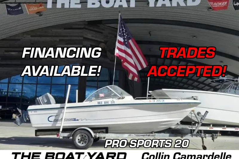 The Image of 1998 Pro Sports 20 boat at dealership, financing and trades available, American flag displayed. - 0