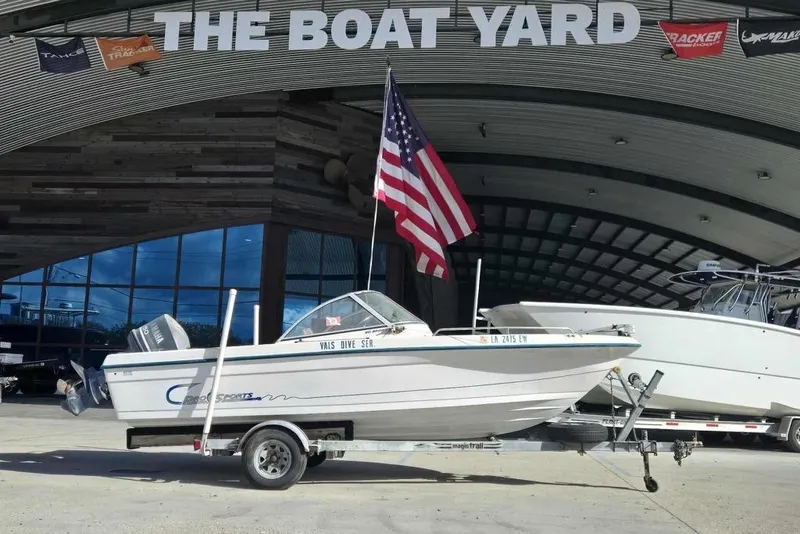 Slide: The Image of 1998 PROSPORT 20cc boat on trailer at The Boat Yard, American flag displayed. - 1