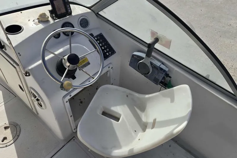 Slide: The Image of 1998 PROSPORT 20cc boat cockpit with steering wheel and control panel. - 10