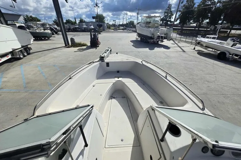 Slide: The Image of 1998 PROSPORT 20cc boat in a marina, showcasing open deck and seating area. - 12
