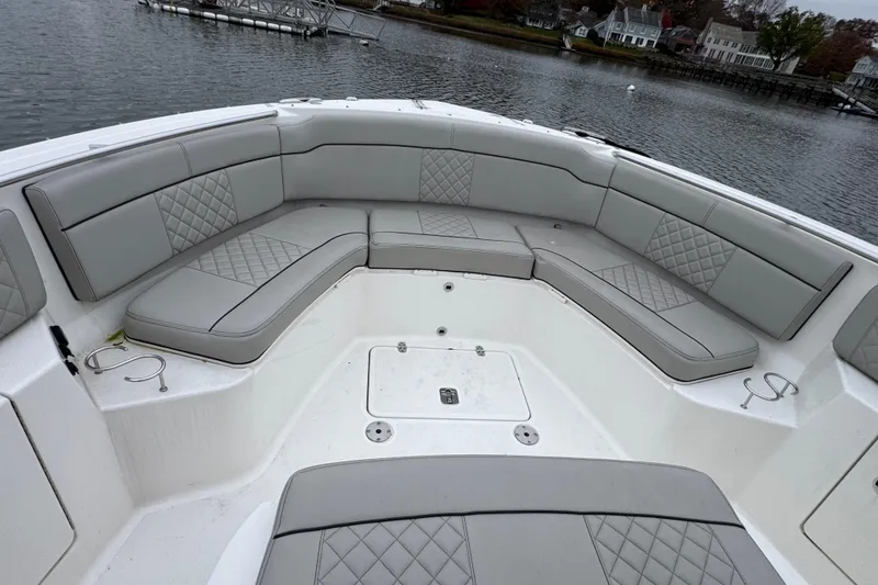 Slide: The Image of 2023 Pursuit S 328 Sport boat helm with dual gray quilted seats and steering wheel. - 10