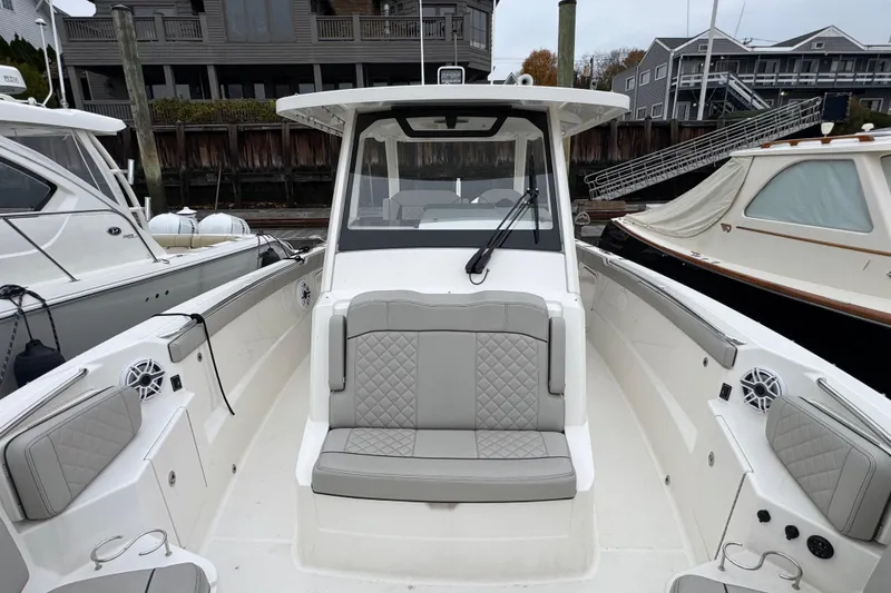 Slide: The Image of 2023 Pursuit S 328 Sport dashboard with dual Garmin navigation screens. - 11