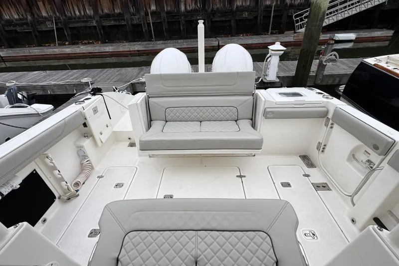 Slide: The Image of 2023 Pursuit S 328 Sport boat with dual 300 V6 engines in a workshop setting. - 2