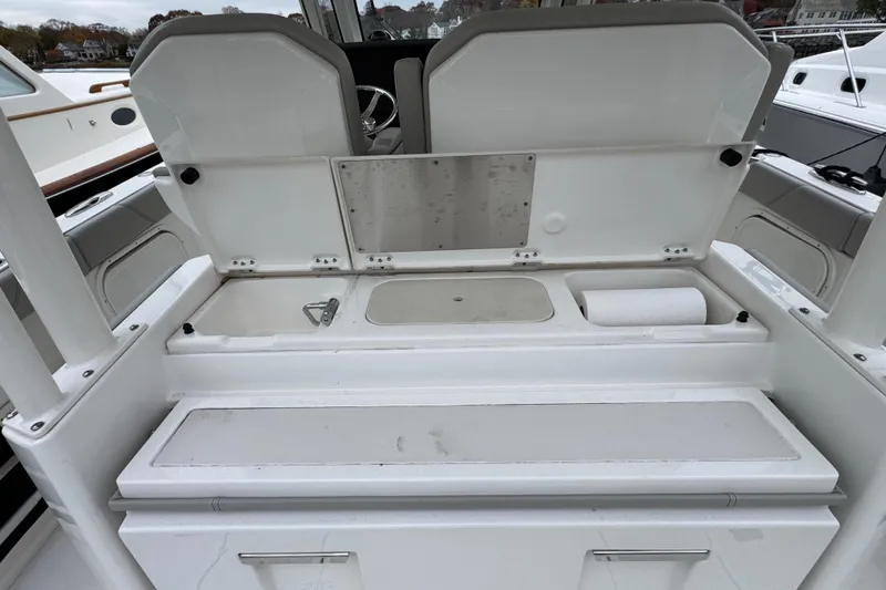 Slide: The Image of 2023 Pursuit S 328 Sport boat with Yamaha engine in a workshop setting. - 3