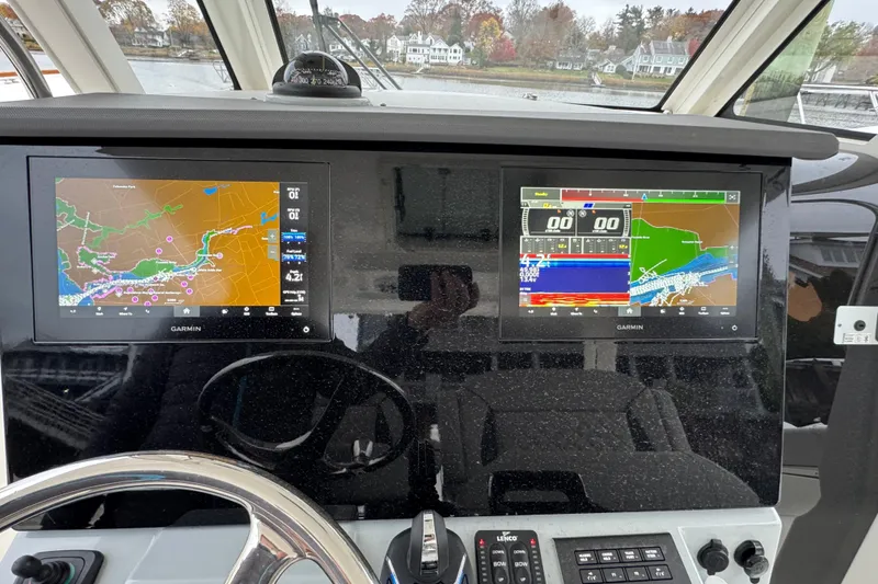 Slide: The Image of 2023 Pursuit S 328 Sport boat with Yamaha engine in a workshop setting. - 5