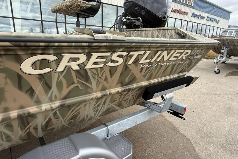 Slide: The Image of 2026 Crestliner 1870 Retriever FCC boat with camouflage design on a trailer. - 10
