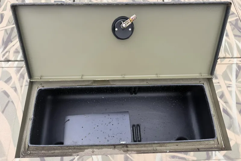 Slide: The Image of Open storage compartment on 2026 Crestliner 1870 Retriever FCC boat, showing interior details. - 11