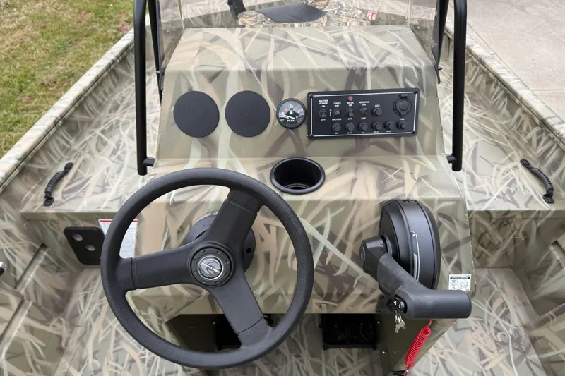 Slide: The Image of 2026 Crestliner 1870 Retriever FCC boat console with camouflage design and steering wheel. - 6