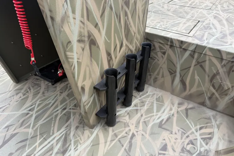 Slide: The Image of Crestliner 1870 Retriever FCC 2026 boat interior with camouflage design and rod holders. - 8