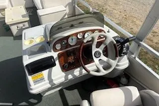 Slide: The Image of 2001 Harris-Kayot Classic 240 O/B boat dashboard with steering wheel and gauges. - 4