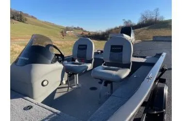 Slide: The Image of 2018 Tracker Super Guide V-16 SC boat with dual seats on a sunny day. - 10