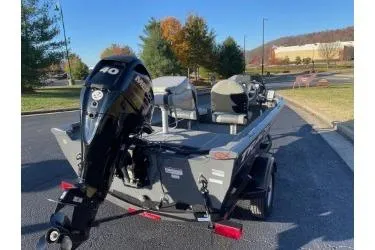 Slide: The Image of 2018 Tracker Super Guide V-16 SC boat with outboard motor on a sunny day. - 4