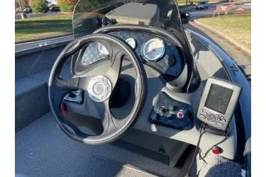 Slide: The Image of 2018 Tracker Super Guide V-16 SC boat dashboard with steering wheel and gauges. - 7