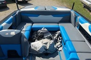 Slide: The Image of 2020 Axis A22 boat interior with blue and gray seating, outdoor setting. - 6