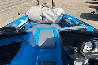 Slide: The Image of 2020 Axis A22 boat with blue and gray interior, parked on a sunny day. - 9