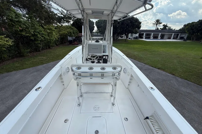 Slide: The Image of 2008 Contender 23 Open boat interior with steering console and rod holders. - 10