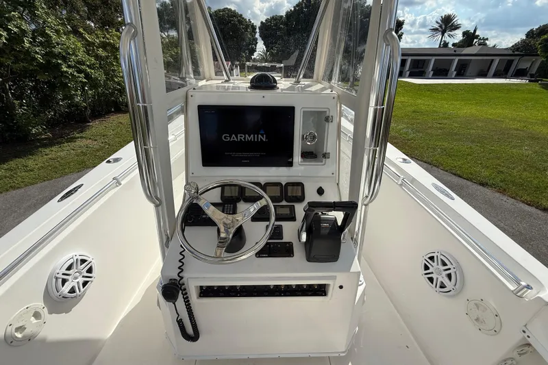 Slide: The Image of 2008 Contender 23 Open boat console with Garmin navigation system and steering wheel. - 13
