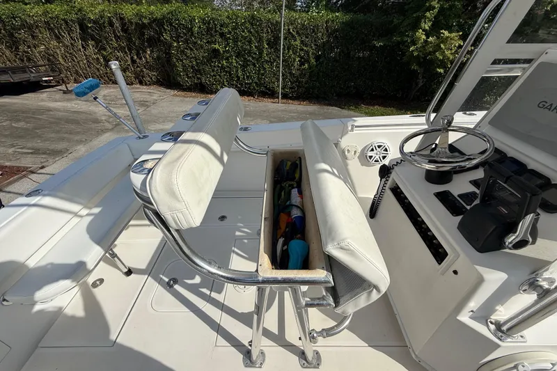 Slide: The Image of 2008 Contender 23 Open boat interior with storage and steering console. - 14