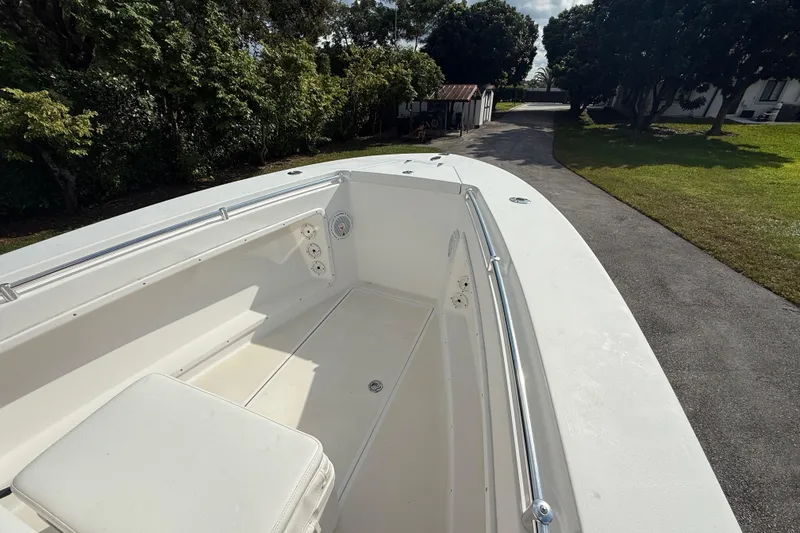 Slide: The Image of 2008 Contender 23 Open boat deck with seating, surrounded by lush greenery. - 18