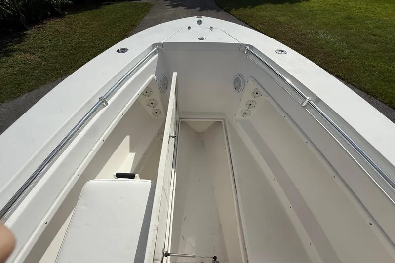 Slide: The Image of 2008 Contender 23 Open boat interior with storage compartments and seating. - 19