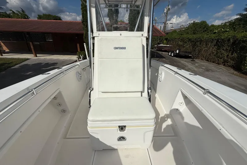Slide: The Image of 2008 Contender 23 Open boat interior with seating and console, under clear skies. - 21