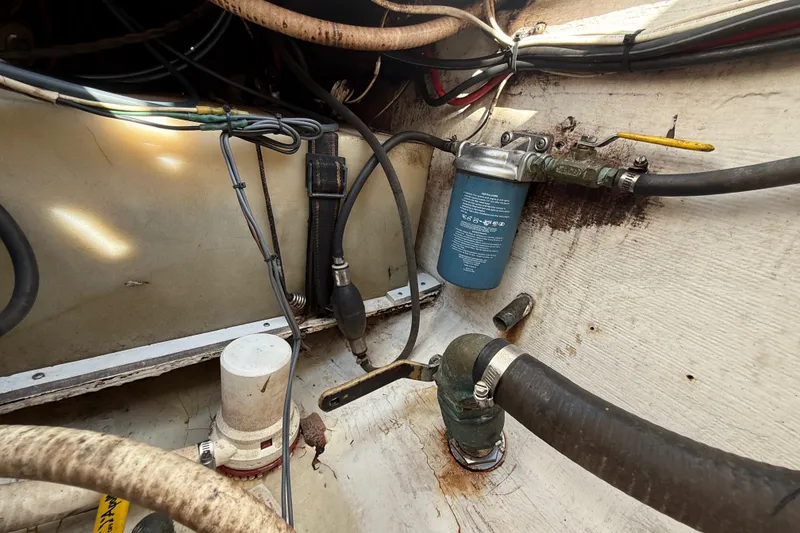 Slide: The Image of 2008 Contender 23 Open boat engine compartment with hoses and filter system. - 25