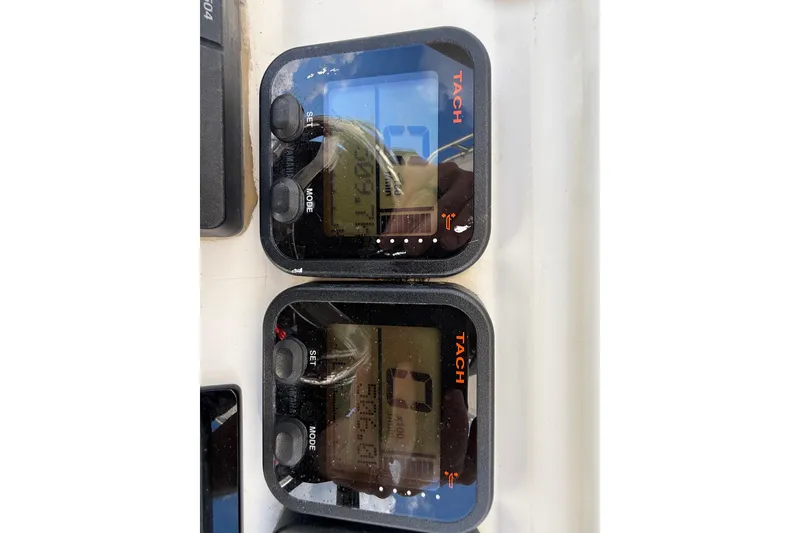 Slide: The Image of Digital tachometers on a 2008 Contender 23 Open boat dashboard. - 28