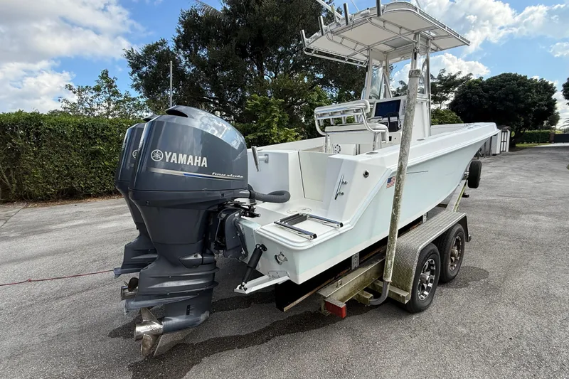 Slide: The Image of 2008 Contender 23 Open boat with Yamaha engine on trailer, parked outdoors. - 5