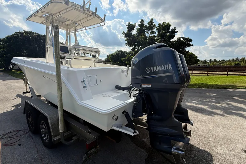 Slide: The Image of 2008 Contender 23 Open boat with Yamaha engine on trailer, parked outdoors. - 7