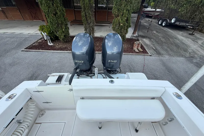 Slide: The Image of 2008 Contender 23 Open boat with dual Yamaha 150 engines, parked outdoors. - 9