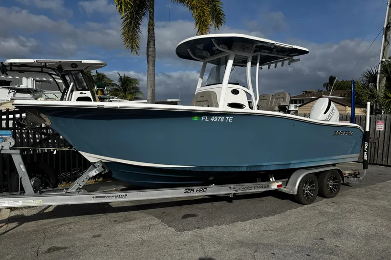 The Image of 2022 Sea Pro 239 Center Console boat on trailer, parked outdoors. - 0
