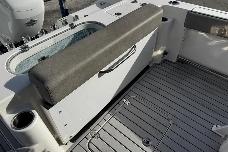 Slide: The Image of 2022 Sea Pro 239 Center Console boat interior with seating and livewell. - 12