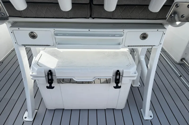 Slide: The Image of 2022 Sea Pro 239 Center Console boat with storage compartment and cooler on deck. - 14