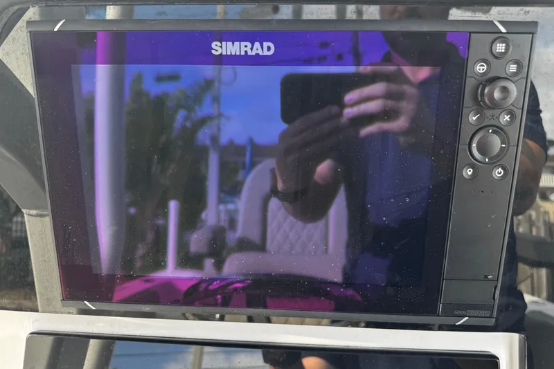Slide: The Image of Simrad display on 2022 Sea Pro 239 Center Console boat, reflecting surroundings. - 22
