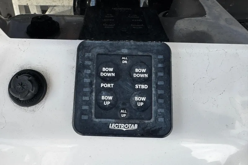 Slide: The Image of Control panel on 2022 Sea Pro 239 Center Console boat with Lectrotab trim tab buttons. - 24
