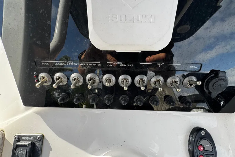 Slide: The Image of Control panel of 2022 Sea Pro 239 Center Console boat with various switches and labels. - 26