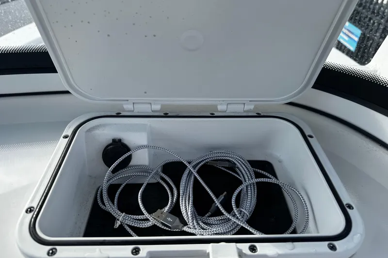Slide: The Image of Open storage compartment on 2022 Sea Pro 239 Center Console boat with coiled rope inside. - 33