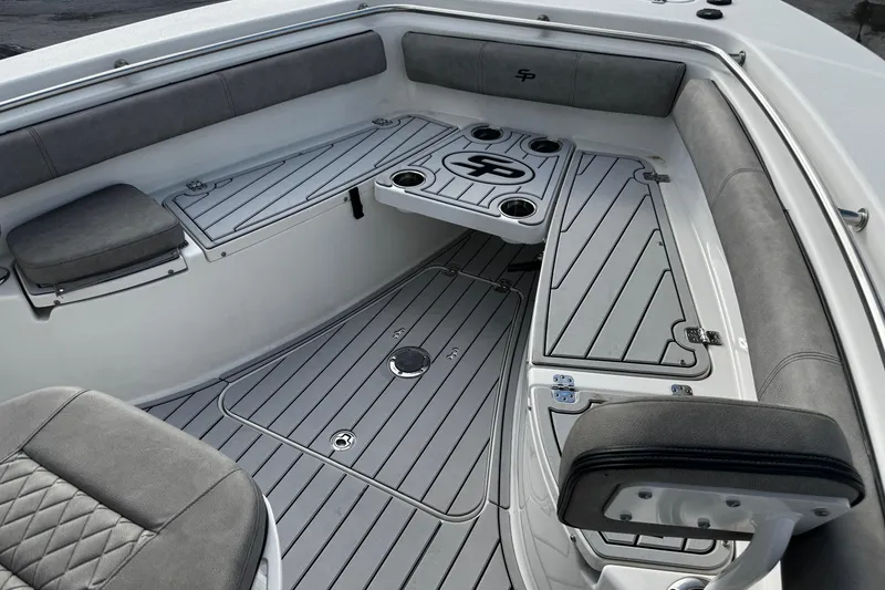 Slide: The Image of 2022 Sea Pro 239 Center Console boat interior with cushioned seating and sleek design. - 36