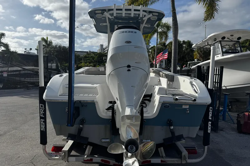 Slide: The Image of 2022 Sea Pro 239 Center Console boat on trailer, parked outdoors with palm trees. - 4