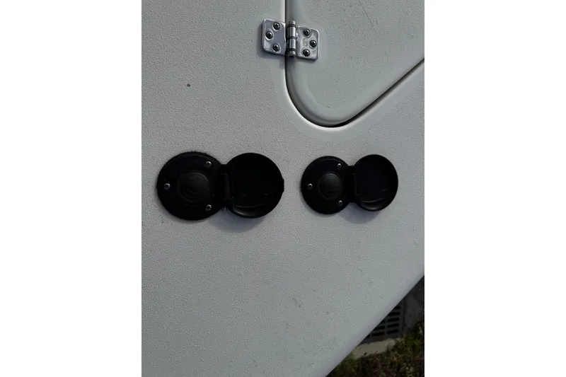 Slide: The Image of 2022 Sea Pro 239 Center Console boat detail with two black circular ports. - 40