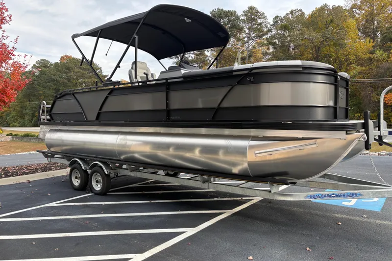 Slide: The Image of 2026 Veranda Relax VR 235 VLI pontoon boat on trailer in parking lot. - 3
