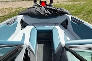 Slide: The Image of 2025 MasterCraft NXT22 boat interior with blue and white seating, outdoor setting. - 5