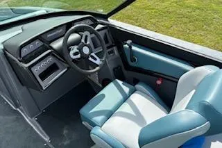 Slide: The Image of 2025 MasterCraft NXT22 boat interior with modern steering and seating. - 6