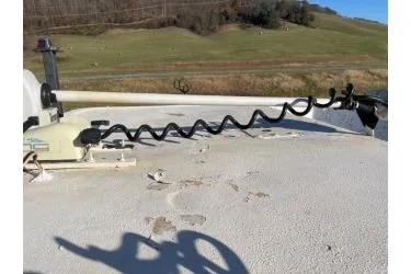 Slide: The Image of 2006 Carolina Skiff 198 DLX boat deck with trolling motor in scenic landscape. - 10