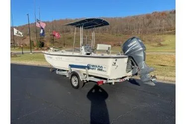 Slide: The Image of 2006 Carolina Skiff 198 DLX boat with Yamaha motor on trailer, parked outdoors. - 2
