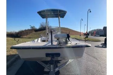 Slide: The Image of 2006 Carolina Skiff 198 DLX boat on trailer, sunny day, outdoor setting. - 3